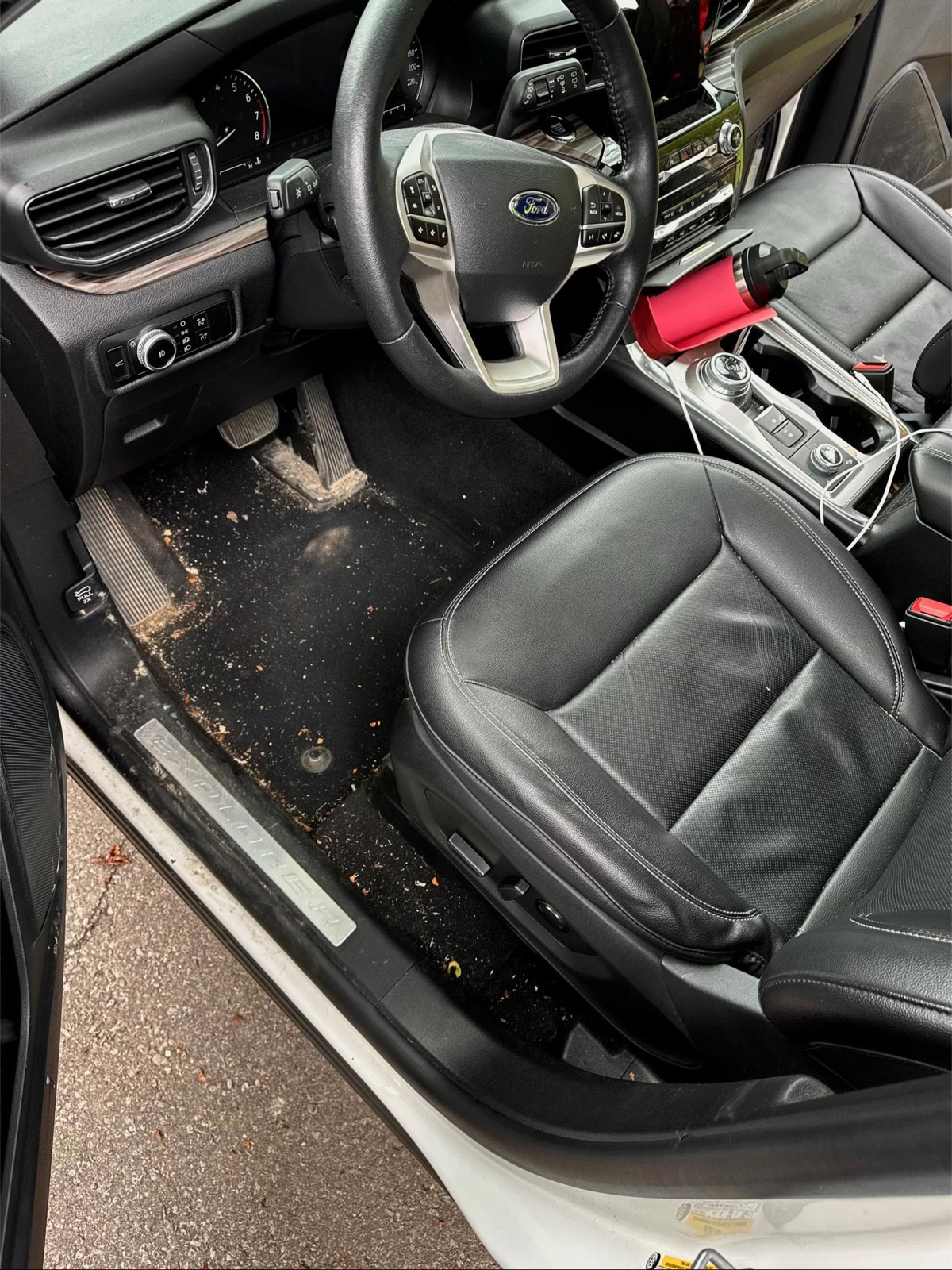 Before: Ford Explorer driver footwell with embedded dirt and debris — Plano, TX