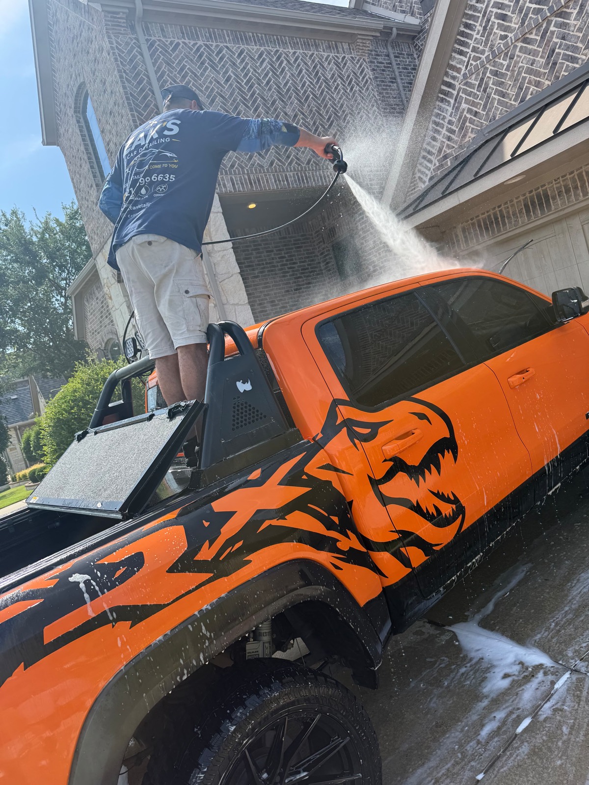 Mobile pressure washing a lifted RAM TRX at a customer's home — Allen, TX